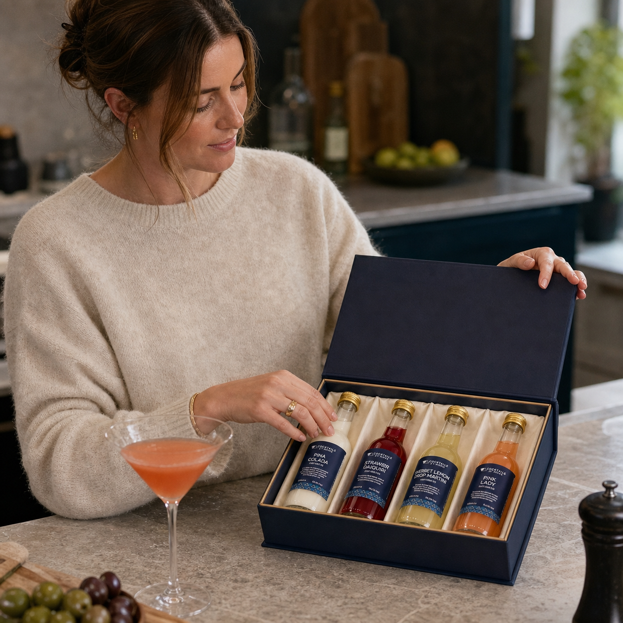 Customer opening a Cocktails At Home presentation box in her kitchen