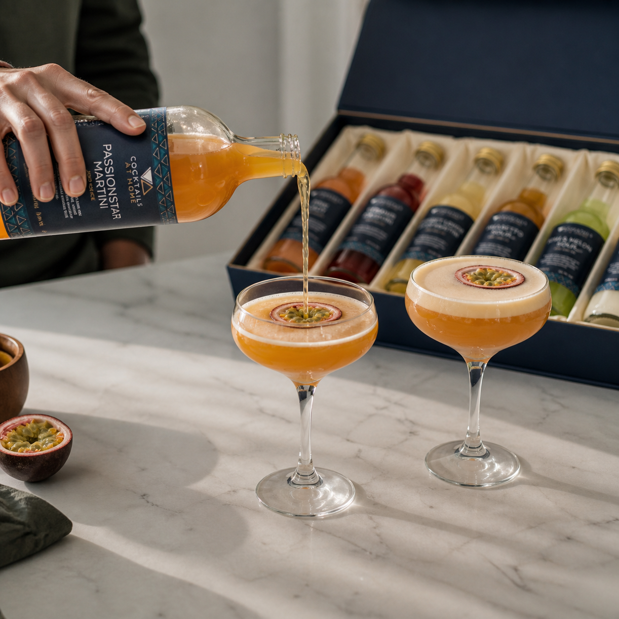 Passion fruit cocktails being poured beside an open cocktail box