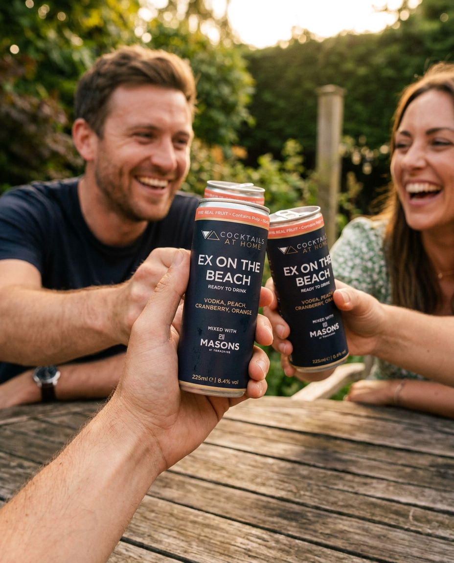 Friends toasting with Ex on the Beach cocktail cans